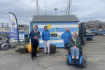 (left-to-right) Craig Hoy MSP with Bryony Capaldi, Lorna Ferry and Carol Murray; using the X8 powered chair