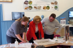 (left-to-right) Suzie Taylor (biologist) showing Rachael Hamilton MSP and Craig Hoy MSP live specimens from the River Tweed