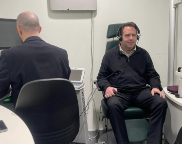 Craig Hoy MSP receiving an audiology exam at Specsavers Galashiels